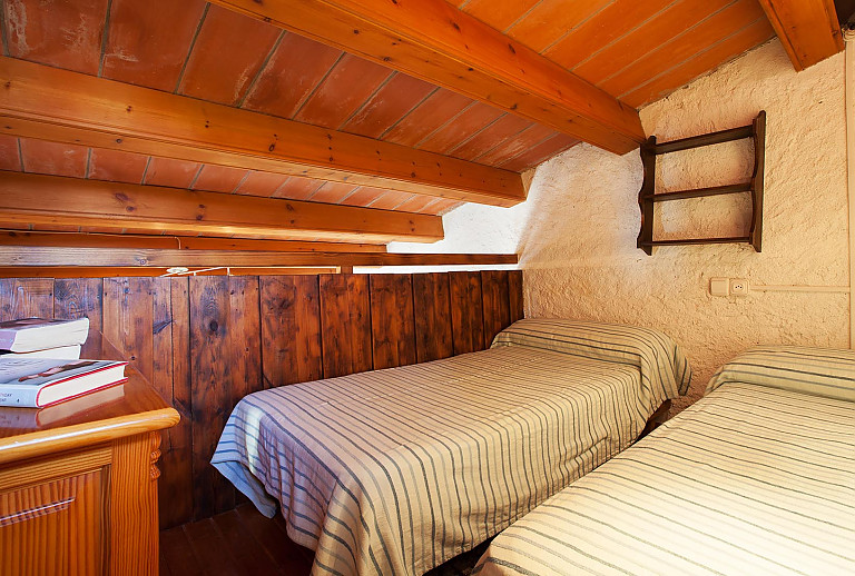 Schlafzimmer Einzelbtten Holzbalken Regale Kommode Buecher