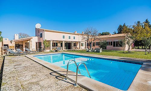 Pool mit Sonnenliegen vor der Finca