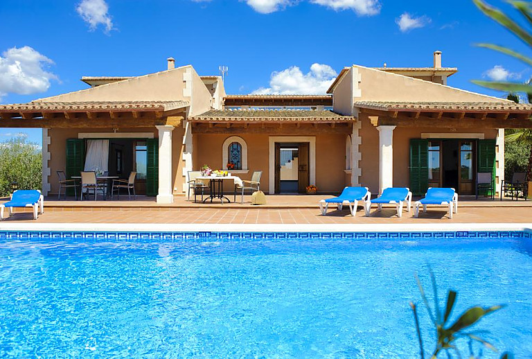 Poolbereich mit Sonnenliegen vor der Finca