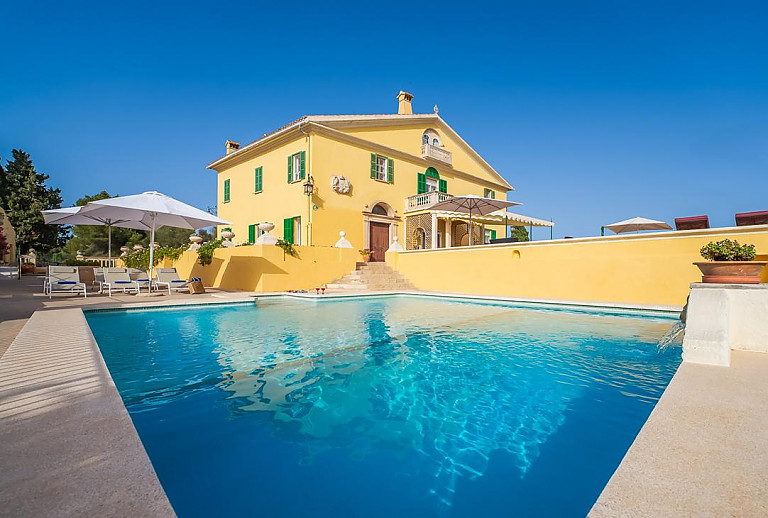 Sonnenliegen und Sonnenschirm am Poolbereich