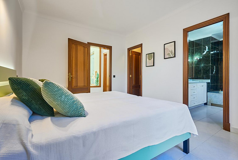 Schlafzimmer mit Doppelbett und Badezimmer